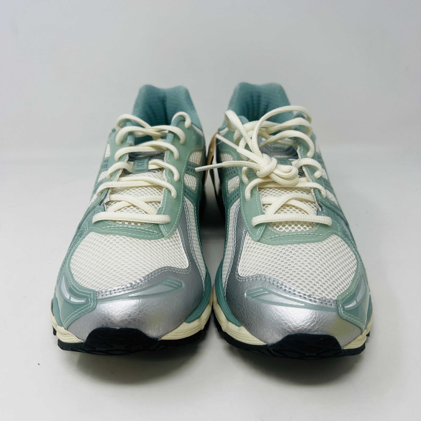 The ASICS Gel-Kayano 12.1 Kith Cream Sage sneakers in pastel green and white feature a breathable mesh design. Theyre accompanied by two packs of extra laces (green and white with black speckles), offering versatile styling for your 100% authentic needs.
