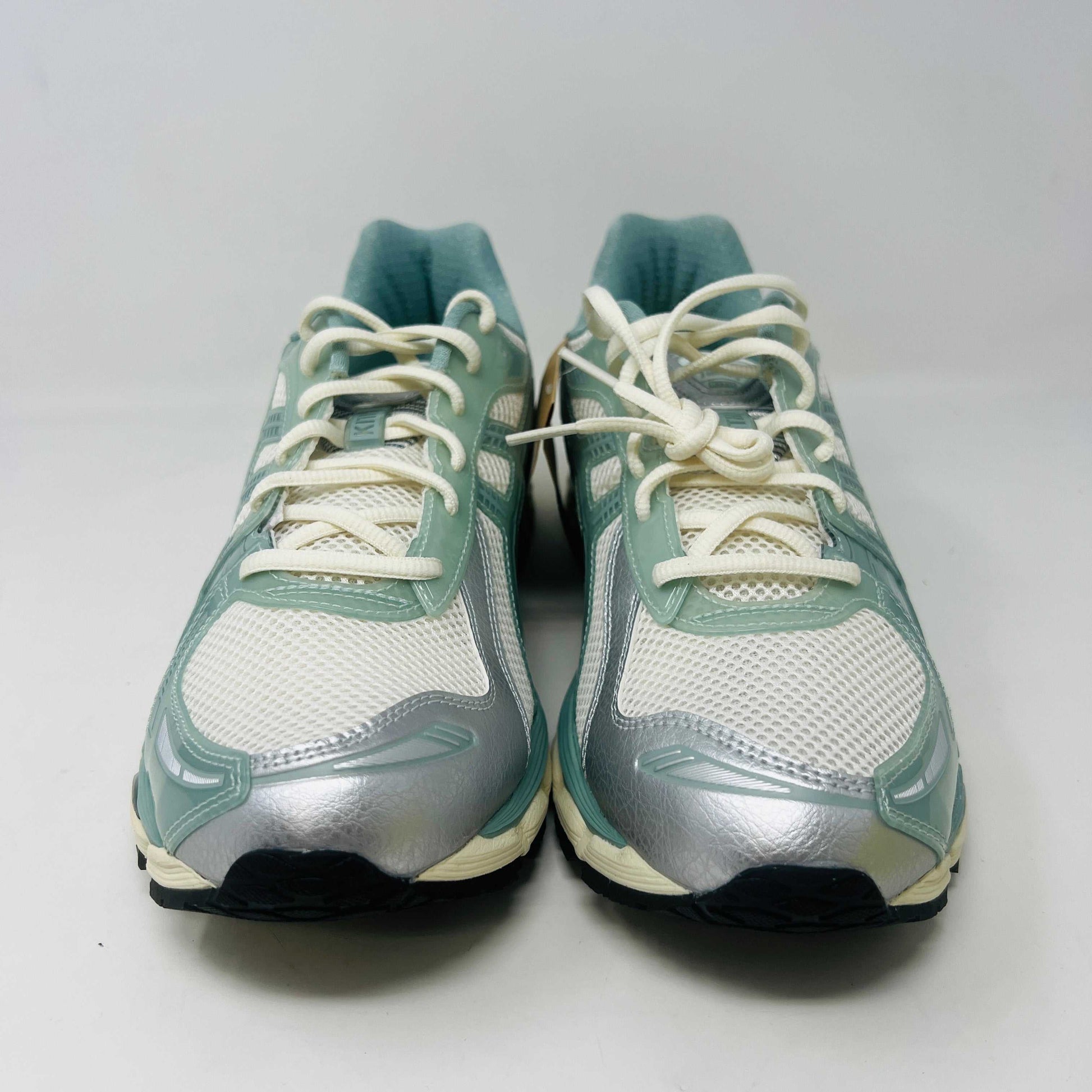 The ASICS Gel-Kayano 12.1 Kith Cream Sage sneakers in pastel green and white feature a breathable mesh design. Theyre accompanied by two packs of extra laces (green and white with black speckles), offering versatile styling for your 100% authentic needs.