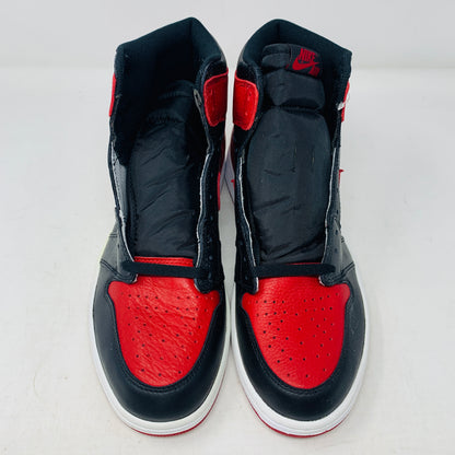 The Jordan 1 High Bred 2016 sneakers, by Jordan, are brand-new black and red high-tops with a white sole. Viewed from above, they showcase an unlaced look with a perforated design on the toe area.
