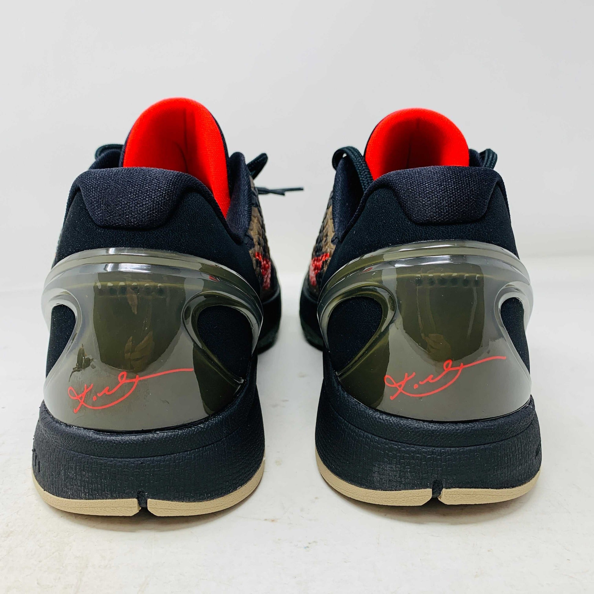 The 2024 Nike Kobe 6 Protro Italian Camo features a textured gray upper with a bright red swoosh, sits on a black shoe box, and has a greenish midsole labeled Zoom. The sleek black lace system completes this authentic sporty sneaker.