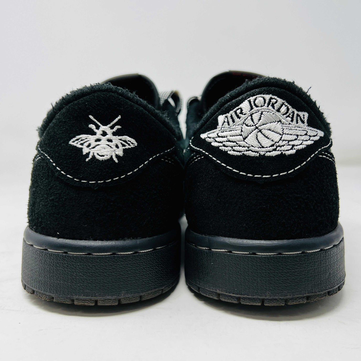 A side view of the Jordan 1 Retro Low OG SP Travis Scott Black Phantom sneaker in black and dark gray with white stitching, size 9.5, displayed on a box with clean uppers and extra laces. A blue sticker shows A2301, with the box label priced at $945.