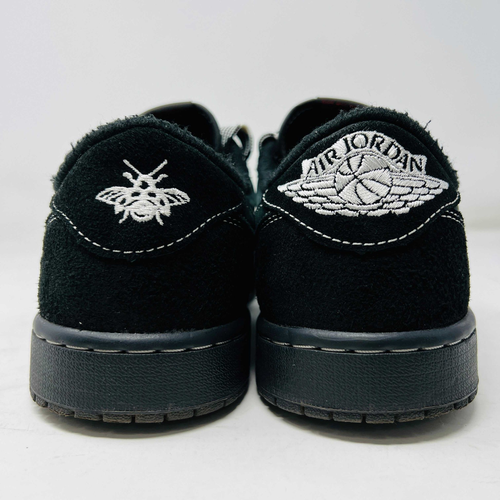 A side view of the Jordan 1 Retro Low OG SP Travis Scott Black Phantom sneaker in black and dark gray with white stitching, size 9.5, displayed on a box with clean uppers and extra laces. A blue sticker shows A2301, with the box label priced at $945.