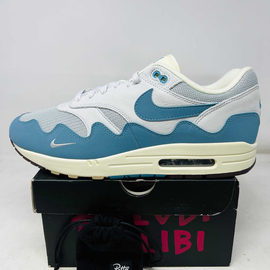 Nike Air Max 1 Patta Waves Noise Aqua sneaker side view on black box with bracelet pouch