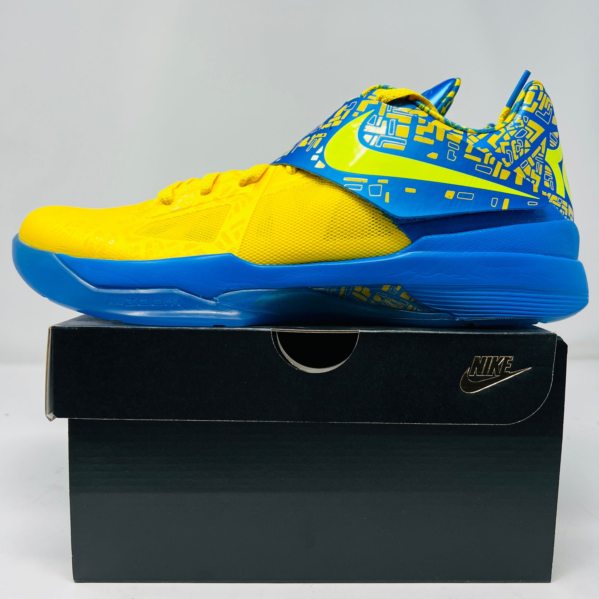 Brand new Nike KD 4 Scoring Title 2025 sneakers, yellow and blue design, on a box.