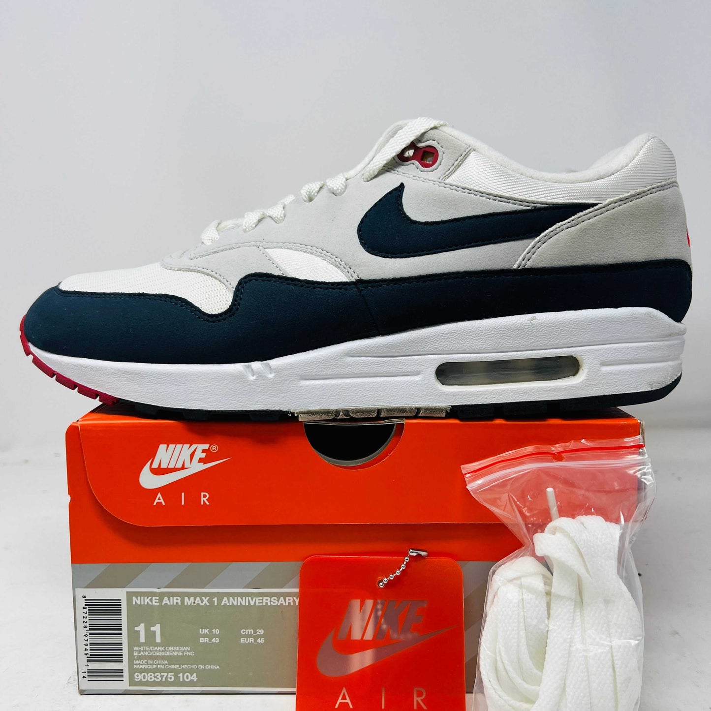 Nike Air Max 1 Anniversary Obsidian sneaker on orange Nike box with extra laces and hang tag, 2017 model