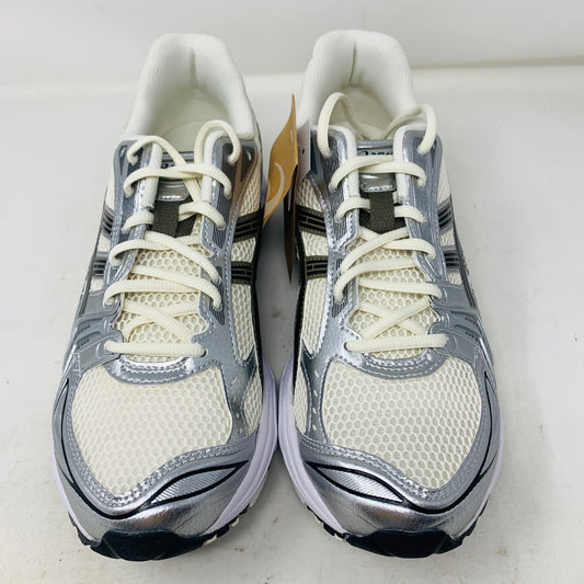 Brand new ASICS Gel-Kayano 14 Cream Black Metallic Plum sneakers rest elegantly on a pristine brown ASICS shoe box. With a mesh upper, metallic accents, and black details, these shoes stand out against a neutral backdrop.