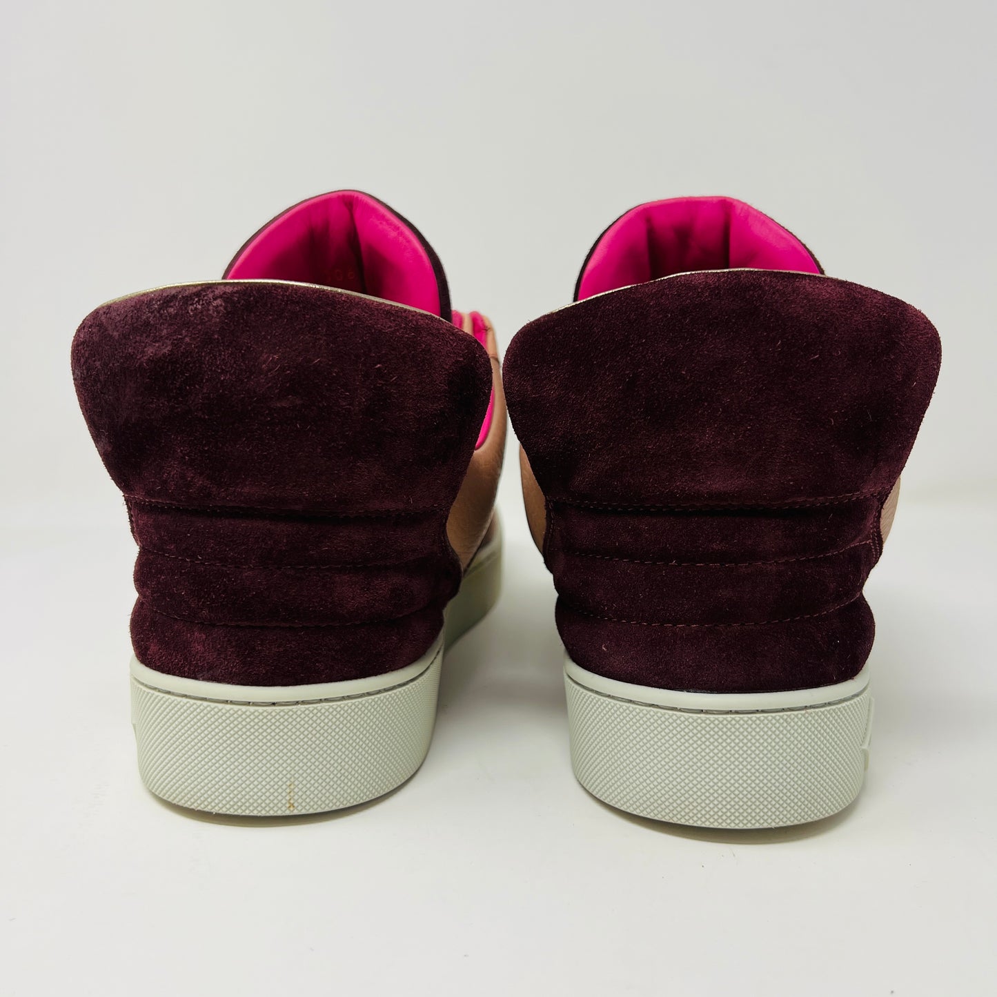 The Louis Vuitton Don Kanye Patchwork high-tops showcase brown and pink leather details with dark brown laces and a logo on the tongue. The white soles have a pink touch at the collar, ideal for size 7 fashionistas seeking extra flair.