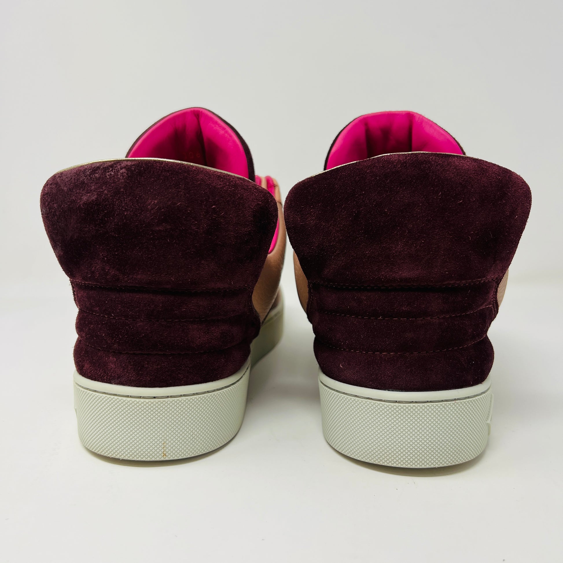 The Louis Vuitton Don Kanye Patchwork high-tops showcase brown and pink leather details with dark brown laces and a logo on the tongue. The white soles have a pink touch at the collar, ideal for size 7 fashionistas seeking extra flair.