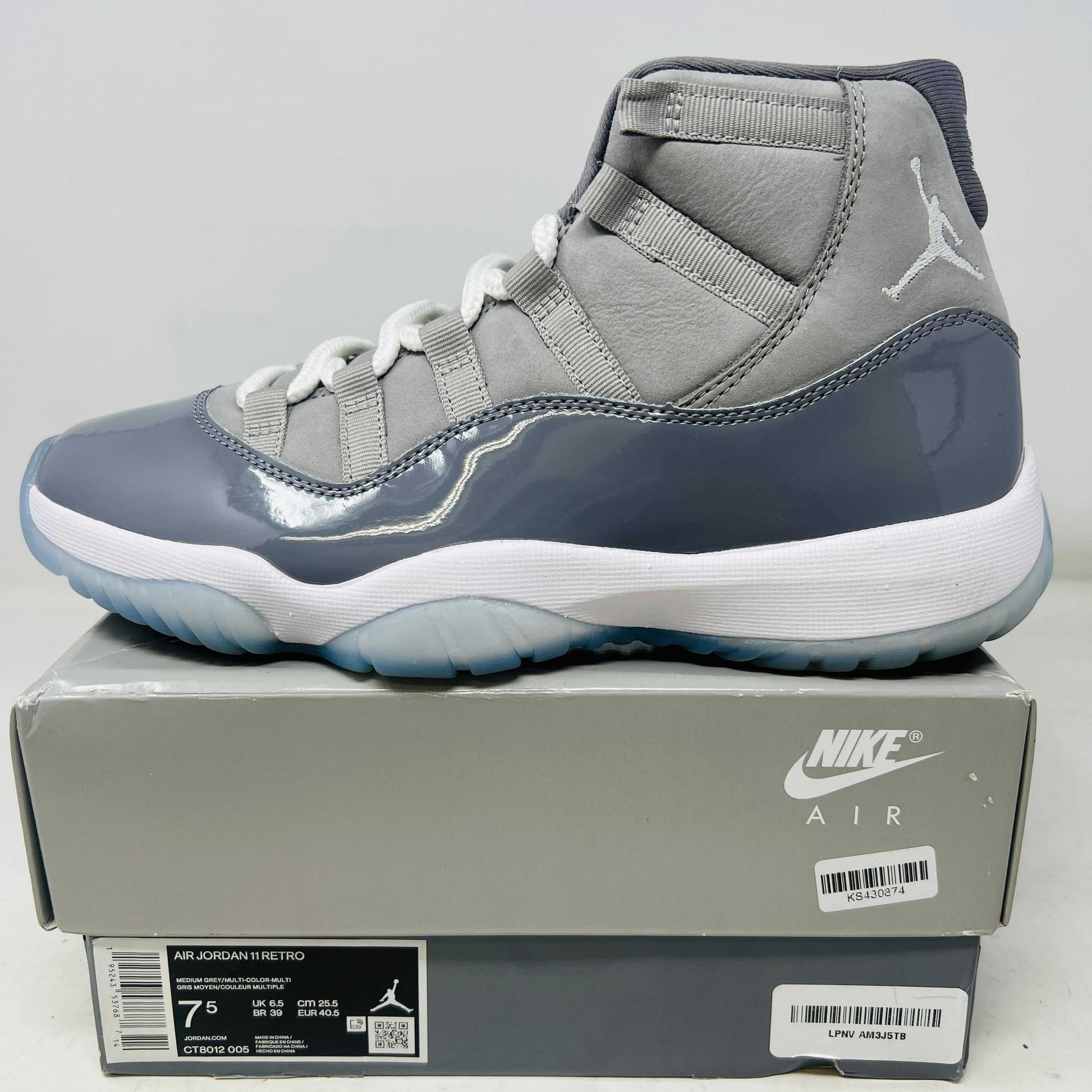 Jordan 11 Retro Cool Grey 2021 sneaker side view on Nike Air box with clean uppers and light wear.