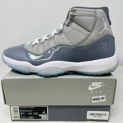 Jordan 11 Retro Cool Grey 2021 sneaker side view on Nike Air box with clean uppers and light wear.