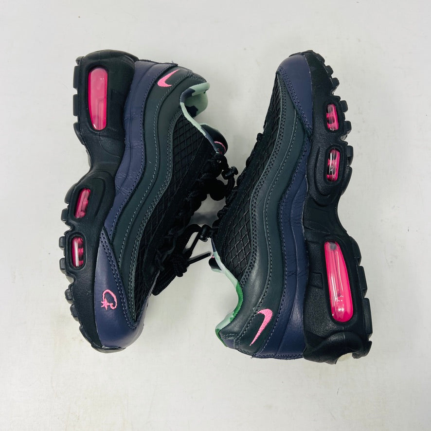Introducing the Nike Air Max 95 SP Corteiz Pink Beam, black sneakers with textured design and purple accents. They feature a pink logo on the tongue, green and gray camo inner lining, black laces with toggle fasteners, fitting perfectly into 2021 fashion trends; available without a box.