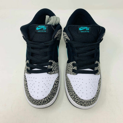 The Nike SB Dunk Low atmos Elephant sneakers feature a black and white textured pattern, teal Nike swoosh, and black laces, displayed on a purple Nike SB box with a white swoosh logo, ensuring 100% authenticity.