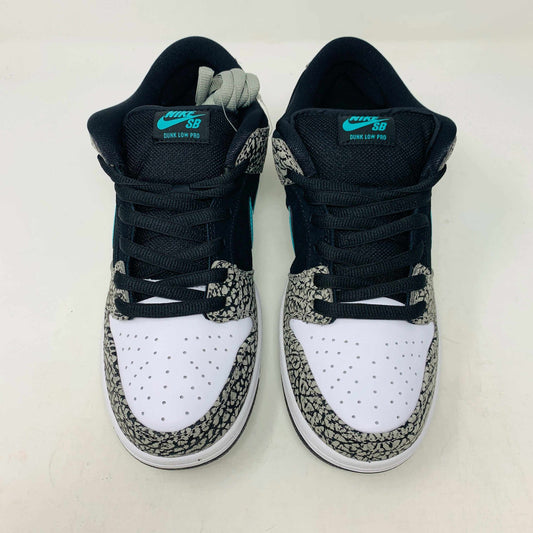 The Nike SB Dunk Low atmos Elephant sneakers feature a black and white textured pattern, teal Nike swoosh, and black laces, displayed on a purple Nike SB box with a white swoosh logo, ensuring 100% authenticity.