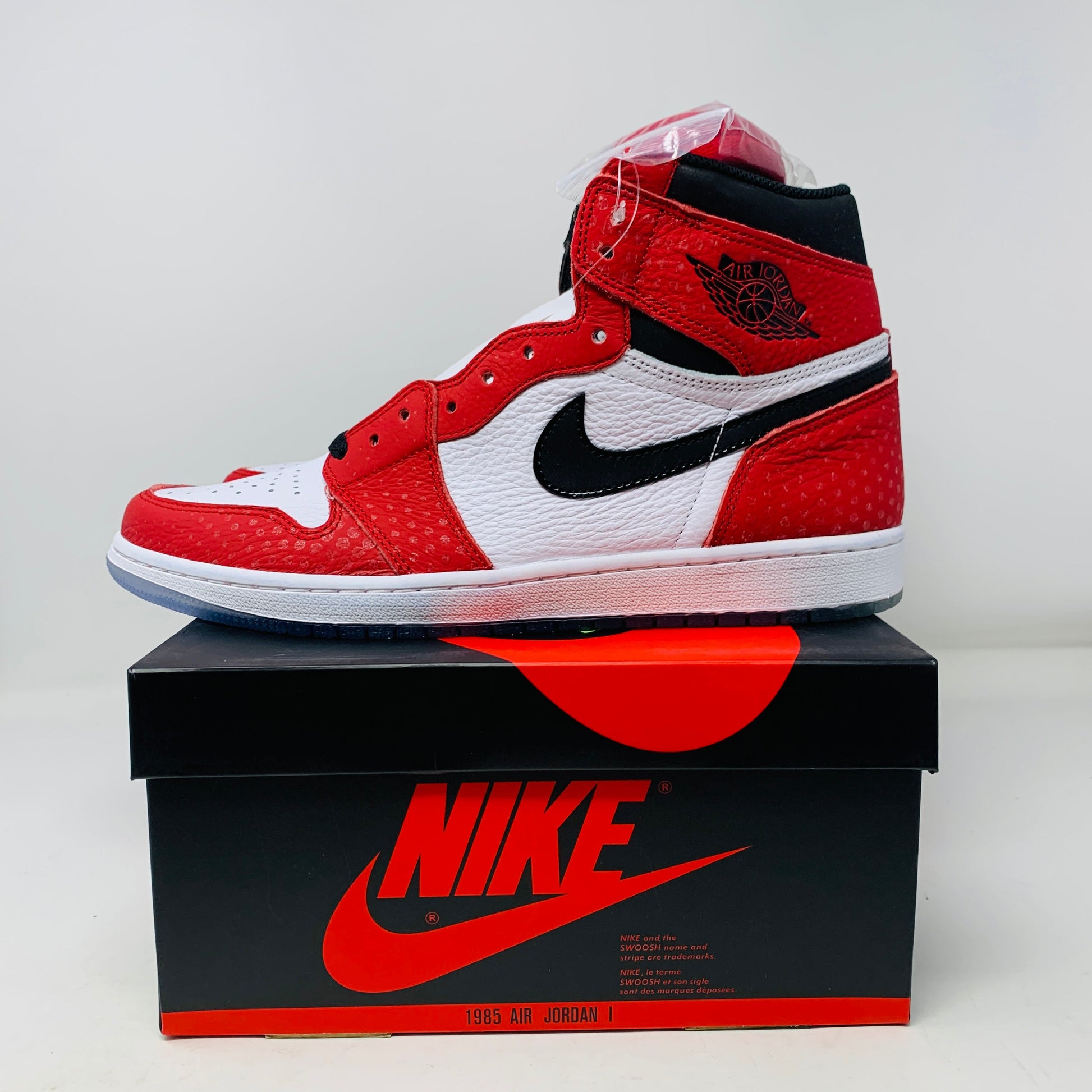 Jordan 1 Spiderman Origin Story sneakers on box, brand new, with extra red laces, 2018 release.