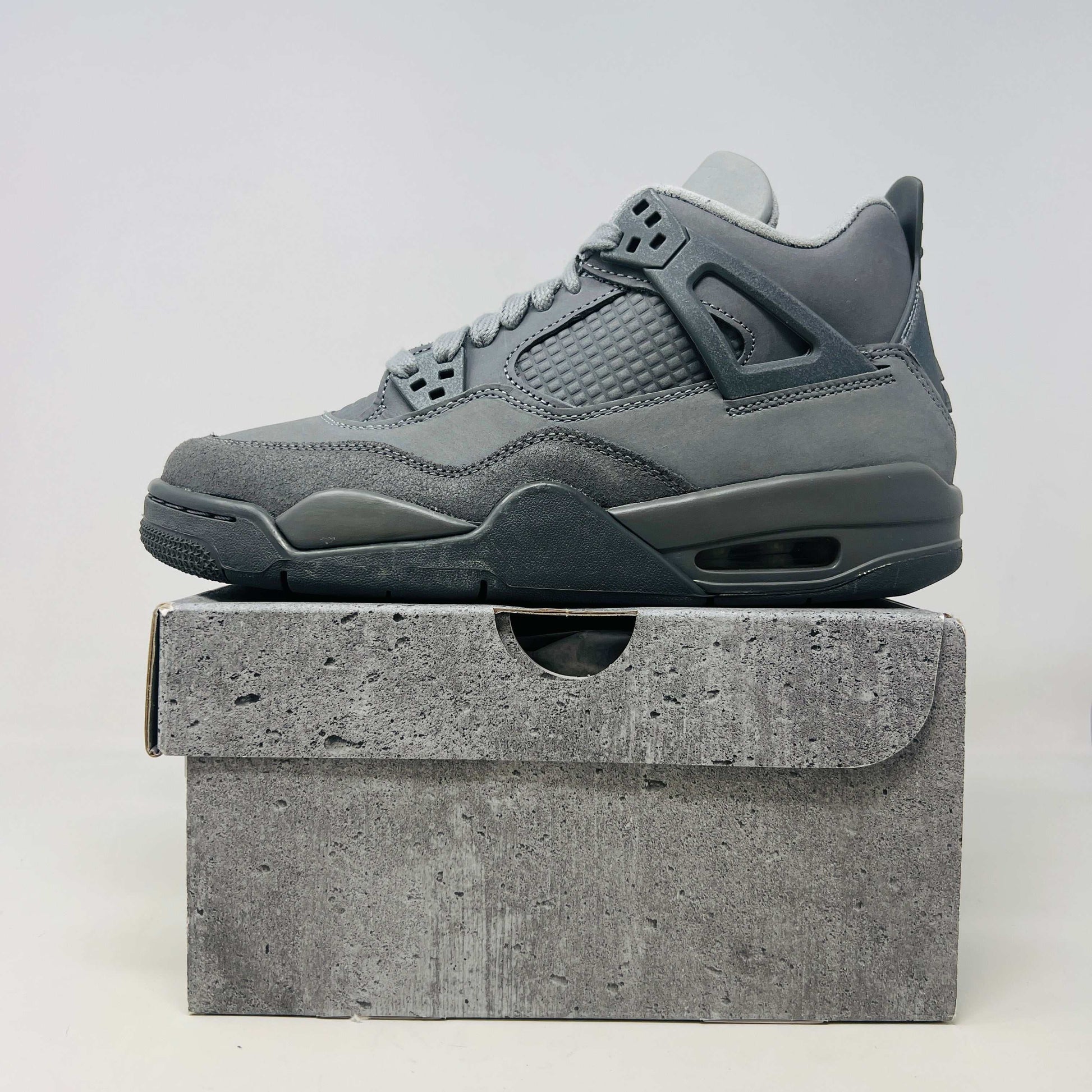 Jordan 4 Retro SE Paris Olympics Wet Cement GS sneaker on a cement-themed box, brand new condition.