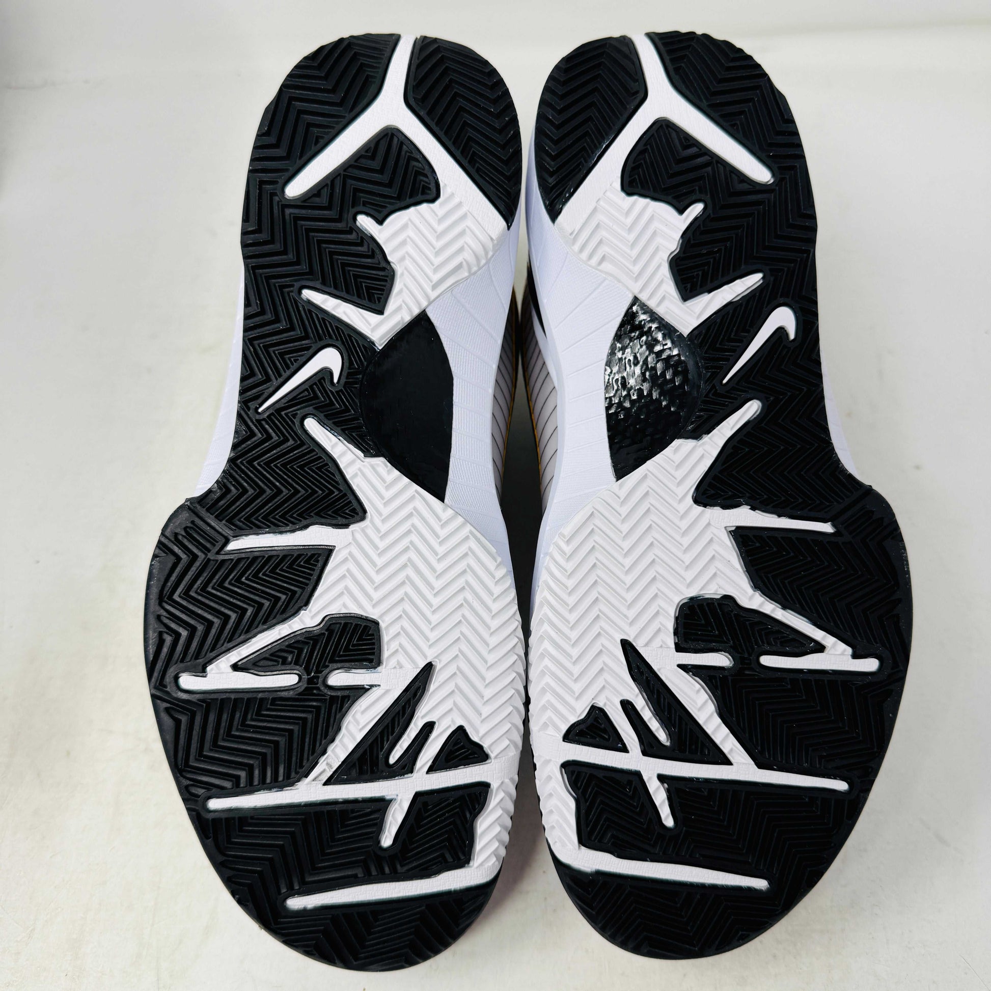 The Nike Kobe 4 Protro White Black Del Sol is a brand-new, authentic Nike sneaker on a shoebox. Predominantly white, it features black and yellow accents with a swoosh logo, a black sole, and yellow-speckled laces, designed for performance and comfort.