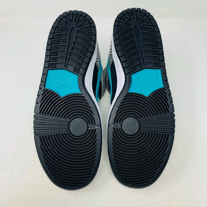 The Nike SB Dunk Low atmos Elephant sneakers feature a black and white textured pattern, teal Nike swoosh, and black laces, displayed on a purple Nike SB box with a white swoosh logo, ensuring 100% authenticity.