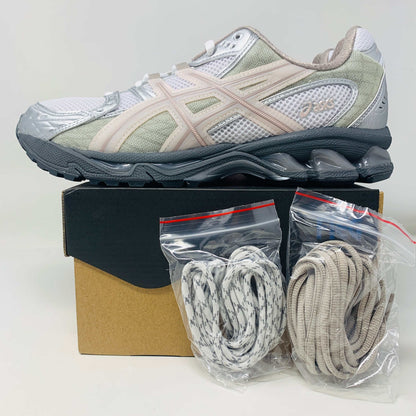 Brand-new ASICS Gel-Nimbus 10.1 Kith White Morganite sneakers, featuring silver and white mesh fabric with beige accents, viewed from above and placed side by side on a plain white background.