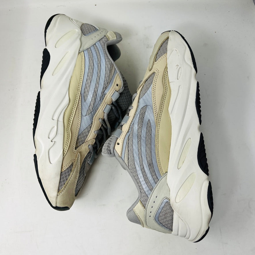 Adidas Yeezy Boost 700 V2 Cream sneakers in beige, gray, and white rest on a brown box labeled Yeezy Boost 700, Made by Adidas, showing minor wear. Box size label: 11.5.