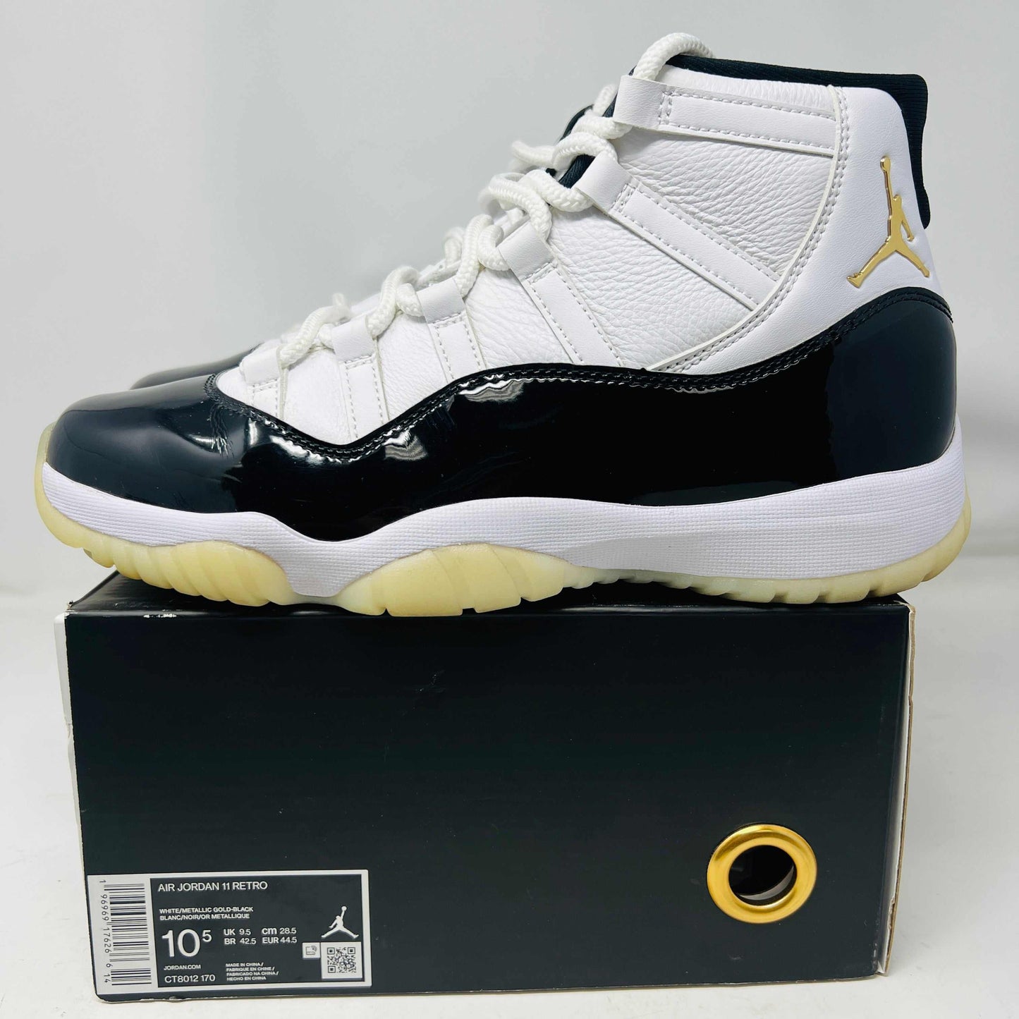 Jordan 11 Retro DMP Gratitude 2023 sneaker with white and black patent leather upper, worn condition, displayed on box