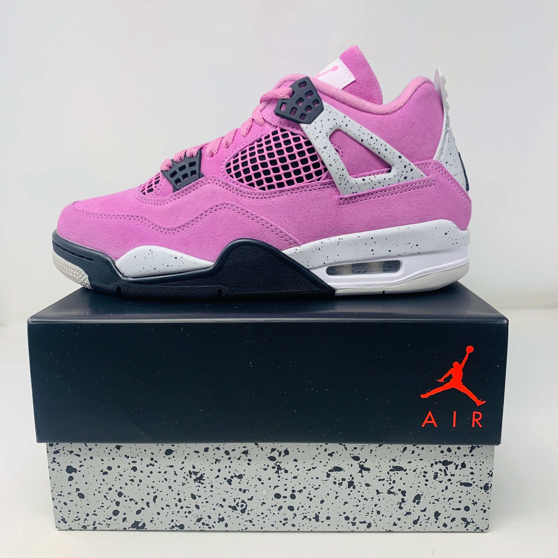Jordan 4 Retro Orchid Women's sneakers in pink with original box.