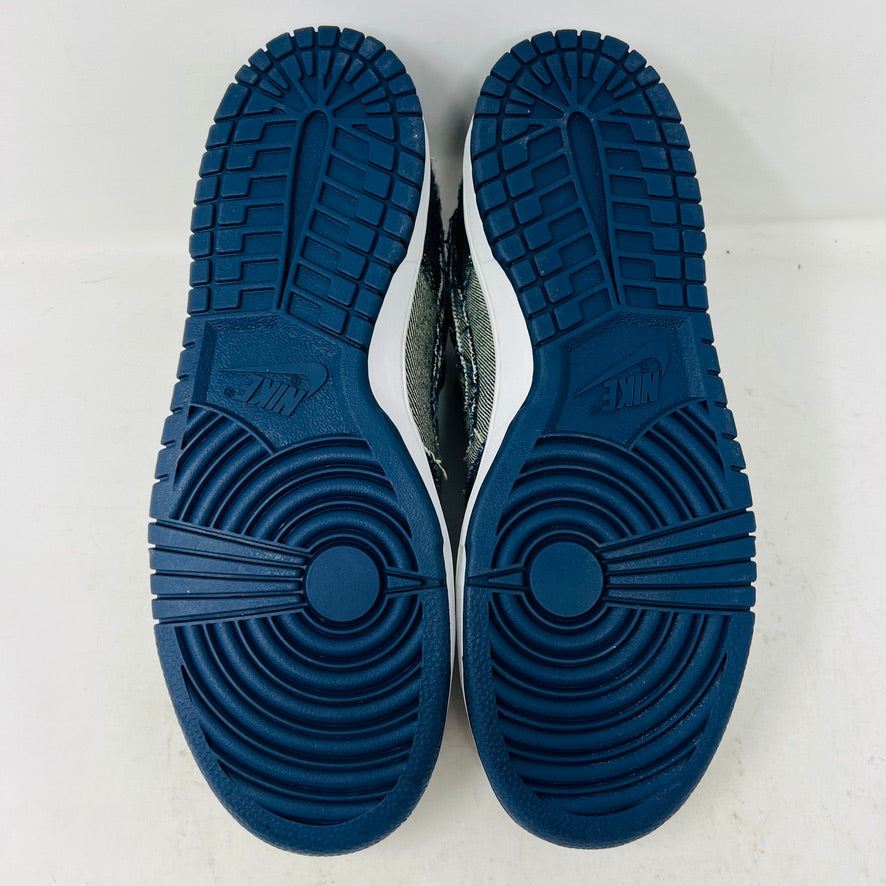 Side view of a brand new Nike Dunk Low CL Denim sneaker with white accents, resting on its orange box. A label reads Denim Dunk. Released in 2006, it features a textured design with a white midsole and blue outsole. Box condition is pristine. Brand: Nike.