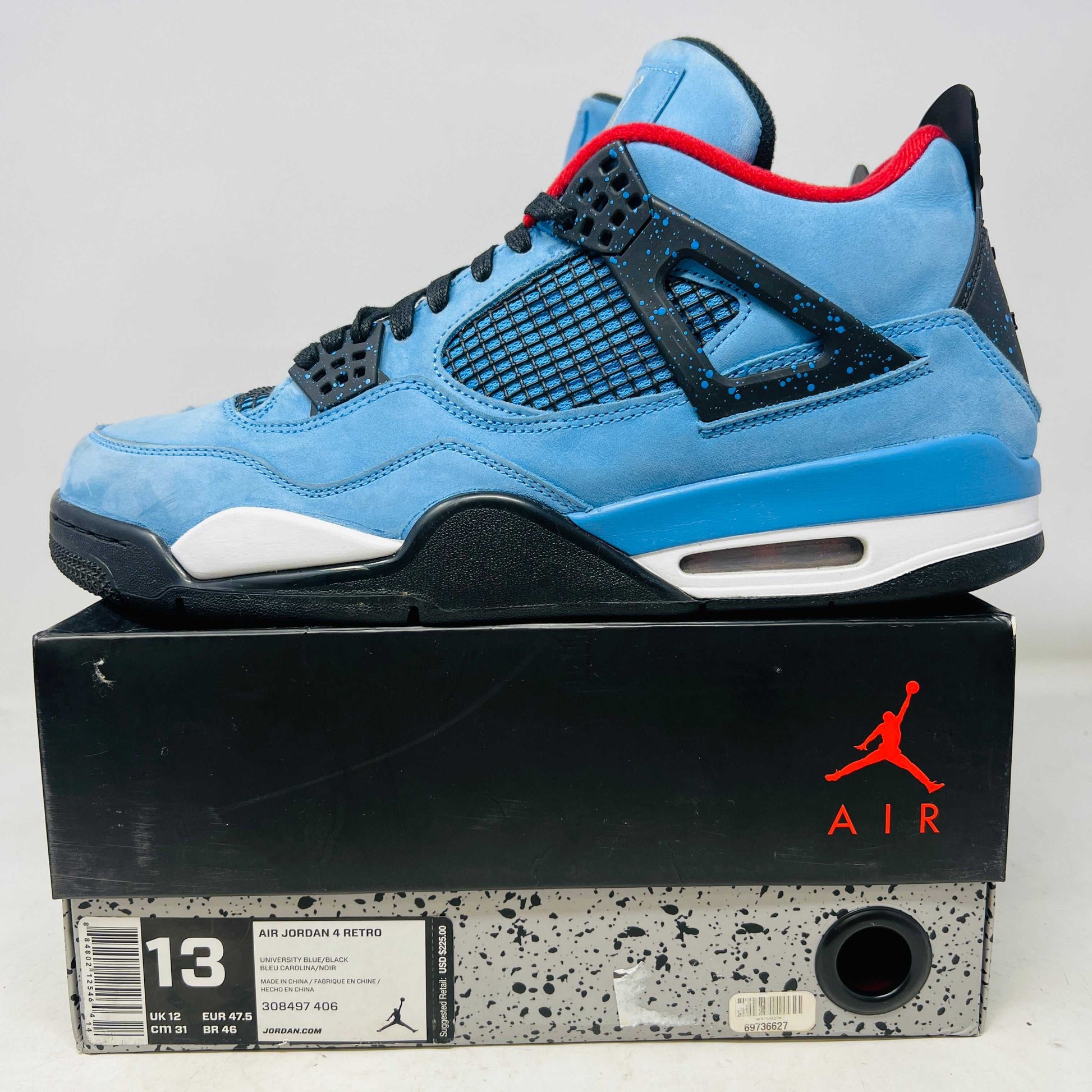 Jordan 4 Retro Travis Scott Cactus Jack blue sneaker on box with minor creasing and good condition logo