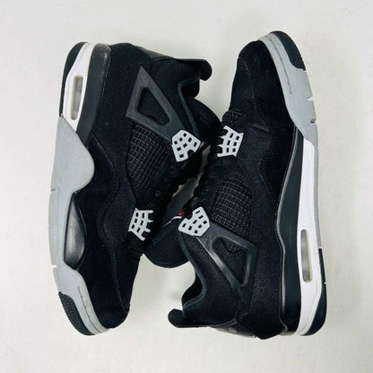 A Jordan 4 Retro SE Black Canvas sneaker in 8/10 condition sits on its shoebox. It features netted side panels, a visible air unit in the heel, and a Jumpman logo on the tongue. The box is marked with size 9.5 and style details.