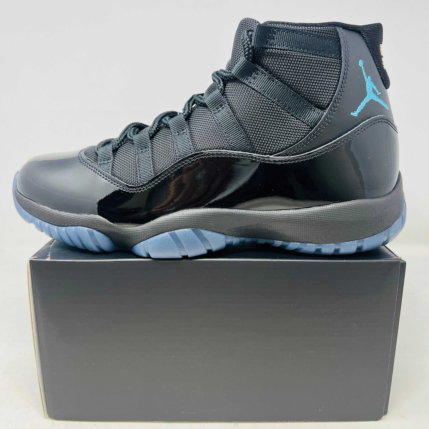 Jordan 11 Retro Gamma Blue 2025 sneaker side view on black box in brand new condition