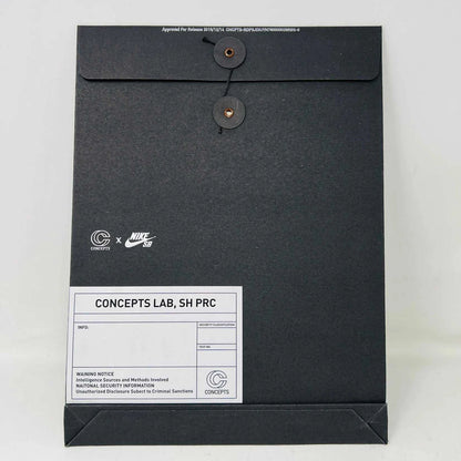 The Nike SB Dunk Low Concepts Green Lobster sneakers, with silver Swooshes and displayed on their Shanghai Special Box, come with extra pink and black laces. They feature green midsoles and a checkered inner lining for that iconic touch.
