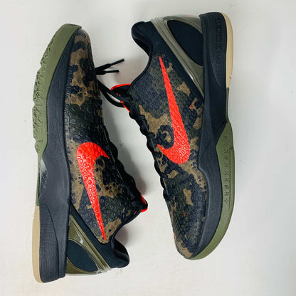 The 2024 Nike Kobe 6 Protro Italian Camo features a textured gray upper with a bright red swoosh, sits on a black shoe box, and has a greenish midsole labeled Zoom. The sleek black lace system completes this authentic sporty sneaker.