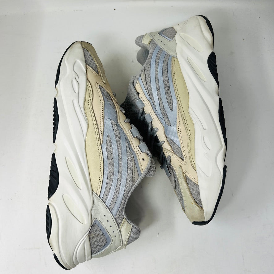 Adidas Yeezy Boost 700 V2 Cream sneakers in beige, gray, and white rest on a brown box labeled Yeezy Boost 700, Made by Adidas, showing minor wear. Box size label: 11.5.