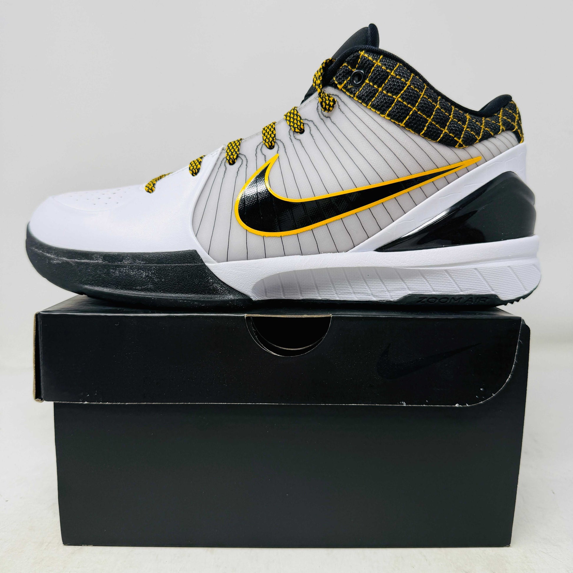 Nike Kobe 4 Protro White Black Del Sol sneaker, brand new, on black shoebox.