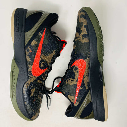 The 2024 Nike Kobe 6 Protro Italian Camo features a textured gray upper with a bright red swoosh, sits on a black shoe box, and has a greenish midsole labeled Zoom. The sleek black lace system completes this authentic sporty sneaker.