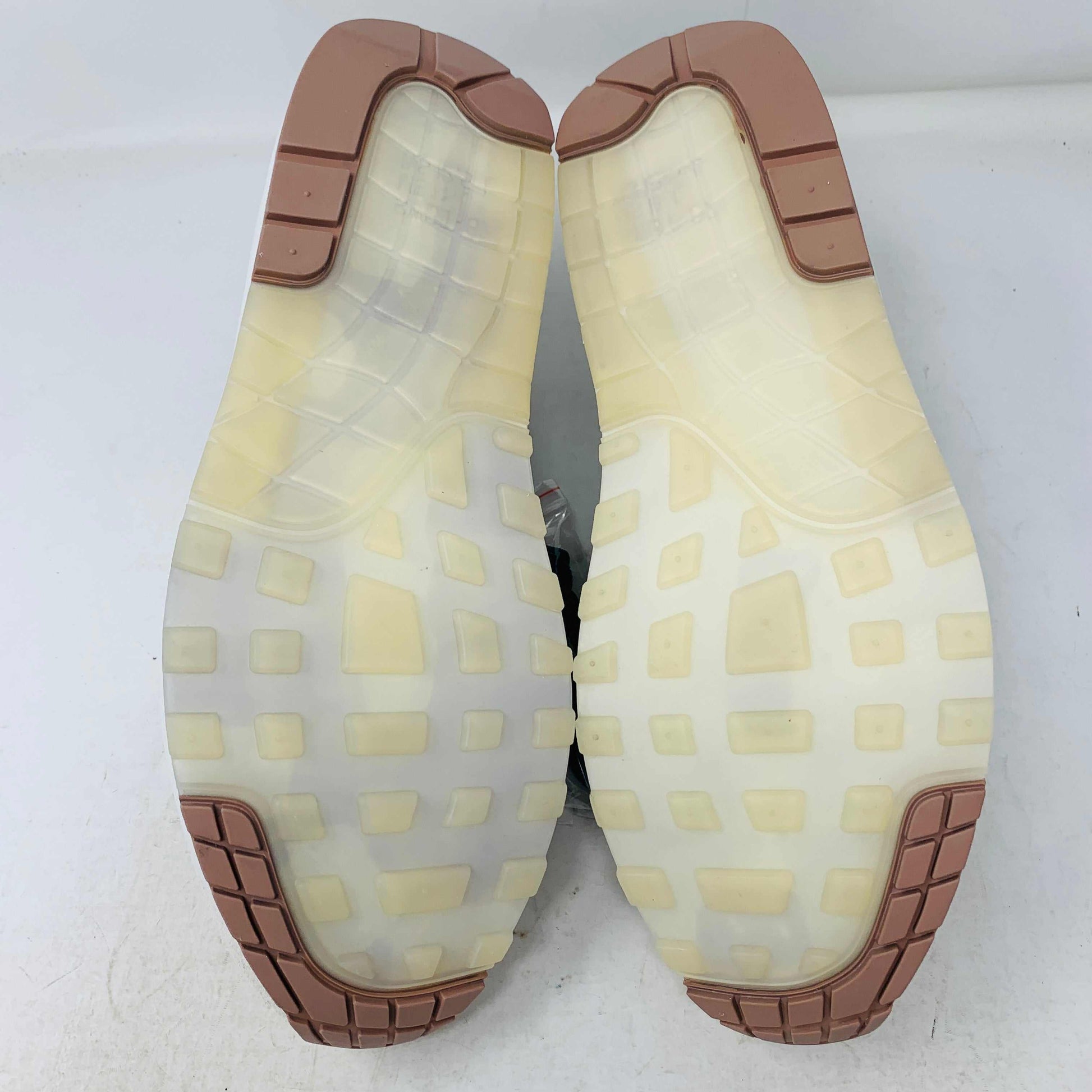 The Nike Air Max 1 87 Premium University of Oregon PE (2024) is a stylish, brand new sneaker featuring a blend of beige, purple, and leopard print with perforated and smooth leather textures. It comes in a vibrant green box and includes a visible air unit in the sole.