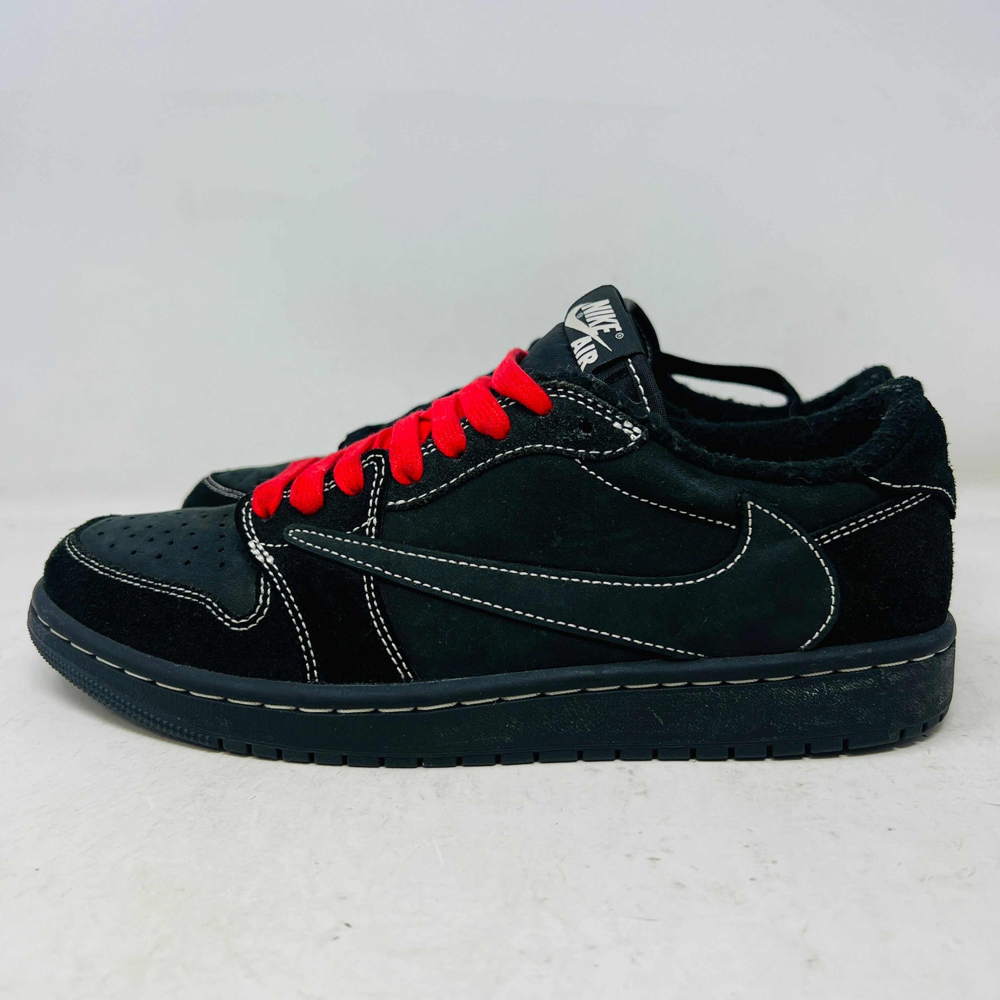 Jordan 1 Retro Low OG Travis Scott Black Phantom sneaker with red laces and black suede upper