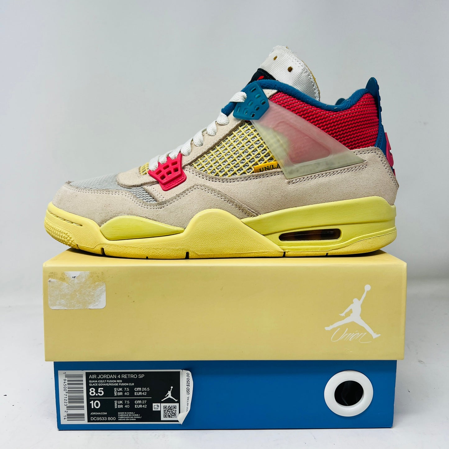 Jordan 4 Retro Union Guava Ice sneaker with yellowing and some wear, displayed on a box; 2020 release.