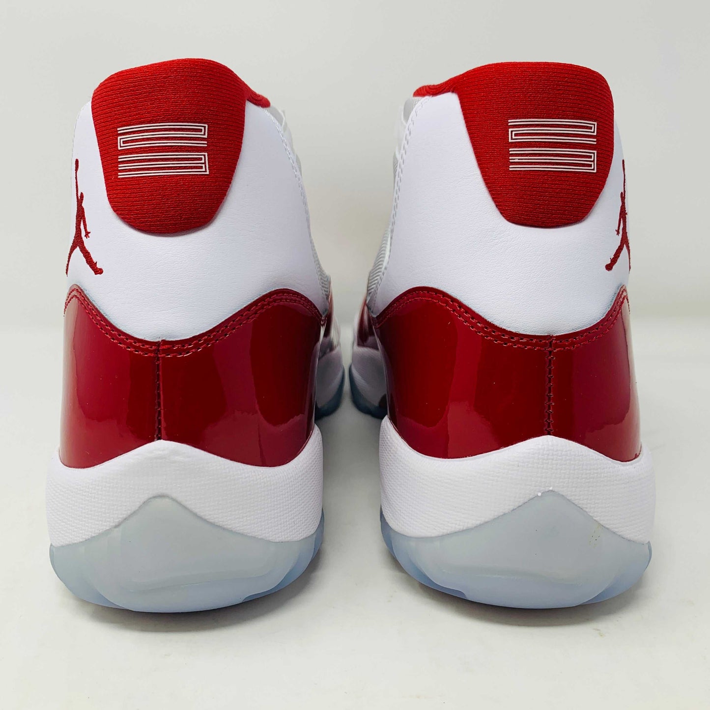 Jordan 11 Retro Cherry 2022 white and red sneakers featuring premium leather and mesh.