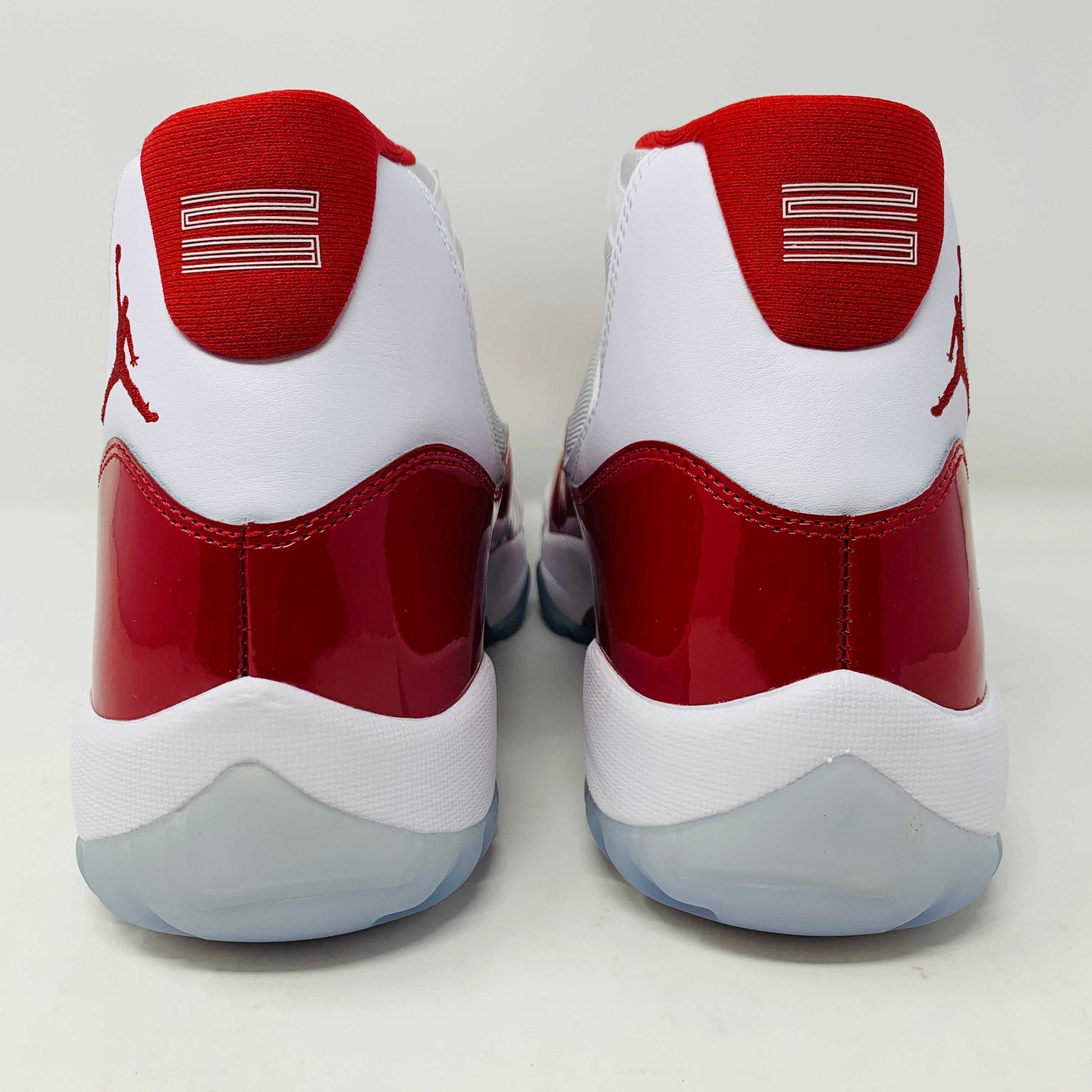 Jordan 11 Retro Cherry 2022 white and red sneakers featuring premium leather and mesh.