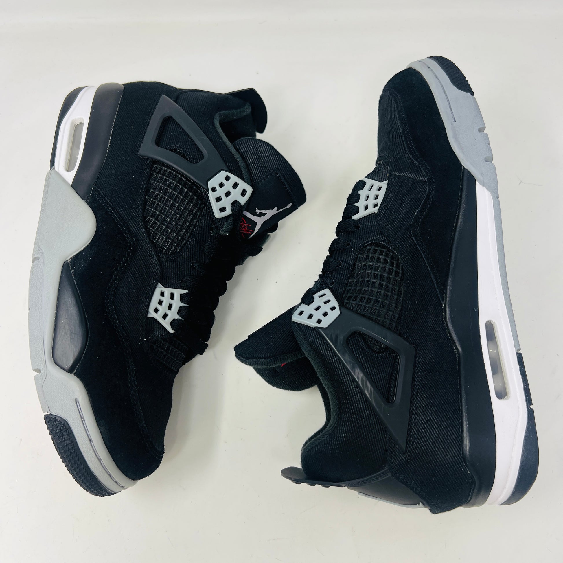 Jordan 4 Retro SE Black Canvas sneakers on box, slight wear.