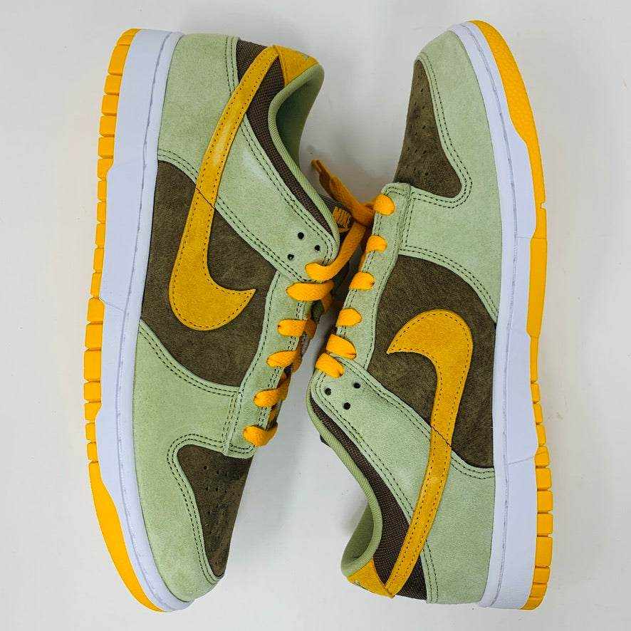Nike Dunk Low Dusty Olive sneakers on an orange box.