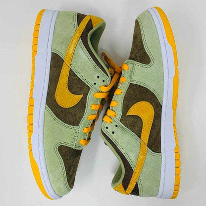 Nike Dunk Low Dusty Olive sneakers on an orange box.