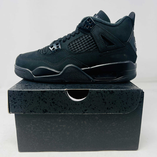 Jordan 4 Retro Black Cat 2025 sneaker in black on black box side view