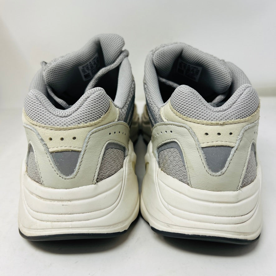 Adidas Yeezy Boost 700 V2 Cream sneakers in beige, gray, and white rest on a brown box labeled Yeezy Boost 700, Made by Adidas, showing minor wear. Box size label: 11.5.