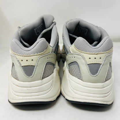 Adidas Yeezy Boost 700 V2 Cream sneakers in beige, gray, and white rest on a brown box labeled Yeezy Boost 700, Made by Adidas, showing minor wear. Box size label: 11.5.