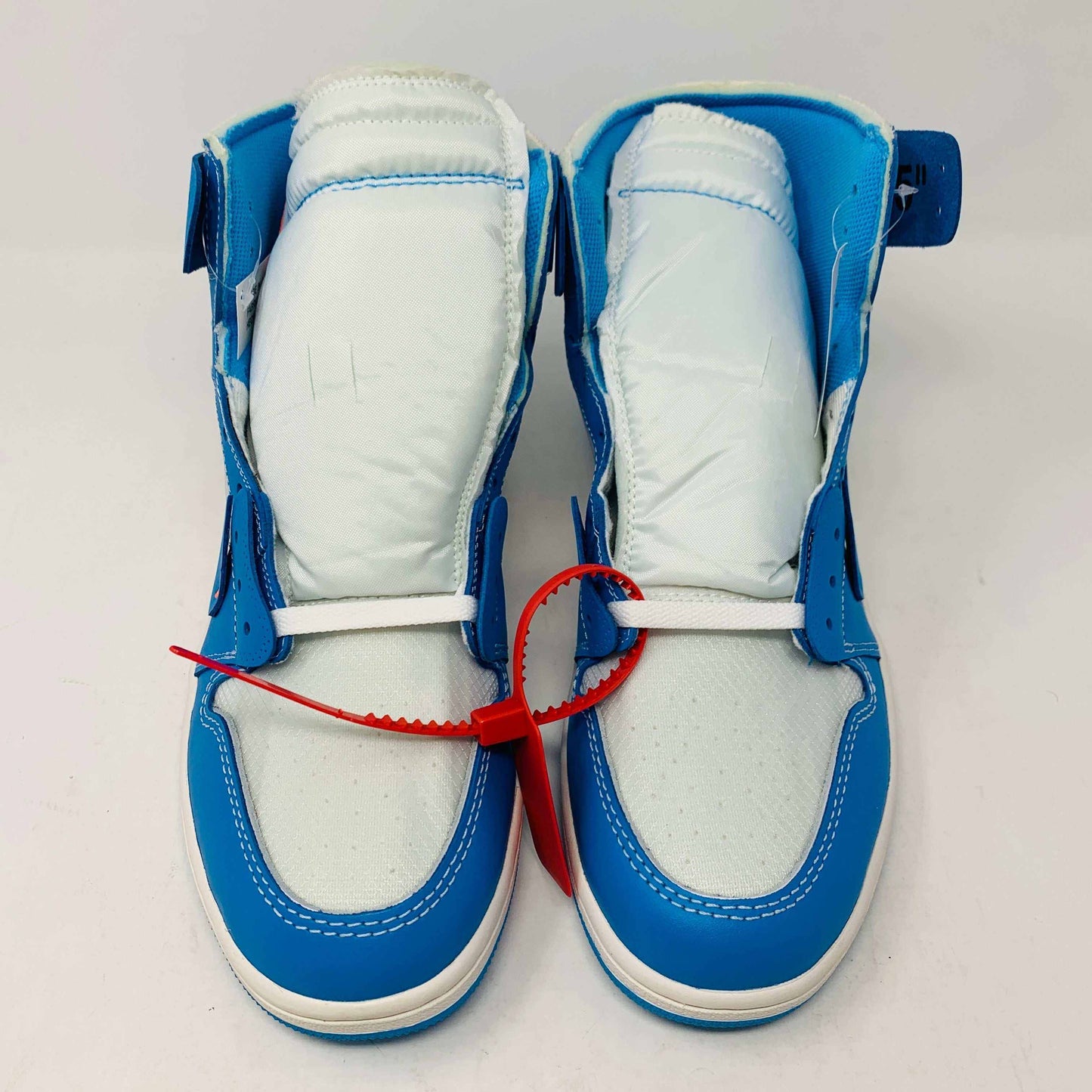 Jordan 1 UNC Off White sneakers with red zip tie and extra shoelaces, brand new condition.