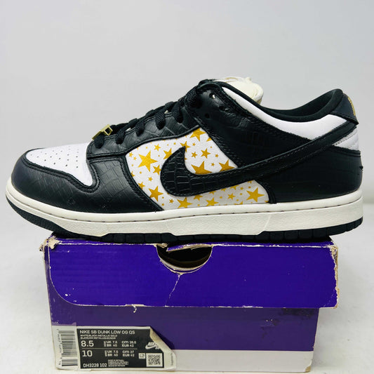 Nike SB Dunk Low Supreme Stars Black sneaker with black and white leather, yellow star pattern, on purple box
