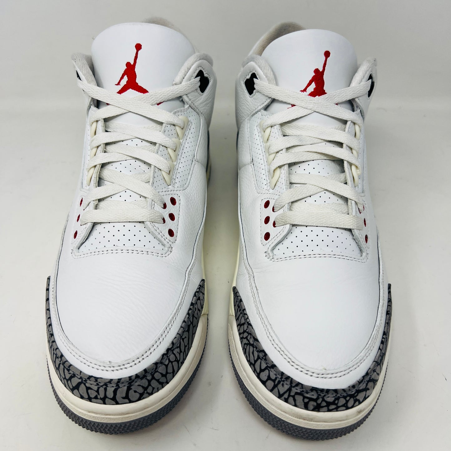 Jordan 3 Retro White Cement sneakers on Nike box, 2023 edition.