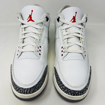 Jordan 3 Retro White Cement sneakers on Nike box, 2023 edition.