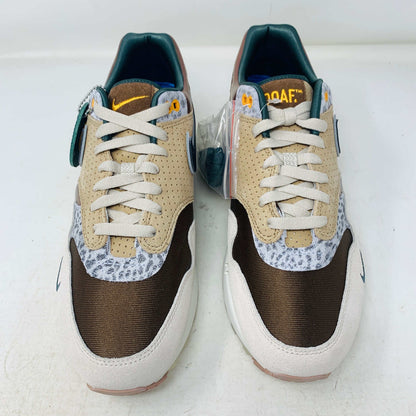 The Nike Air Max 1 87 Premium University of Oregon PE (2024) is a stylish, brand new sneaker featuring a blend of beige, purple, and leopard print with perforated and smooth leather textures. It comes in a vibrant green box and includes a visible air unit in the sole.
